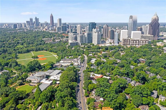 Panoramic view of a cityscape with high-rise buildings and surrounding greenery.
