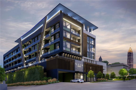 Front view of a modern multi-story building with unique architectural features.
