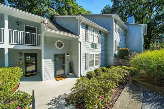 Front view of a two-story house with a light blue exterior and white trim.