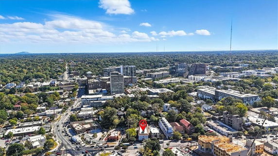Wide angle view of a cityscape with various buildings and trees.