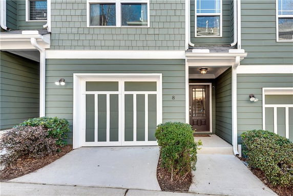 Front view of a house with a garage and entrance door.