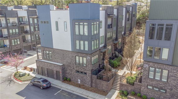 Front view of multi-story residential buildings with brick and modern paneling.