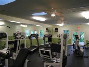 Interior view of a gym with various exercise equipment.