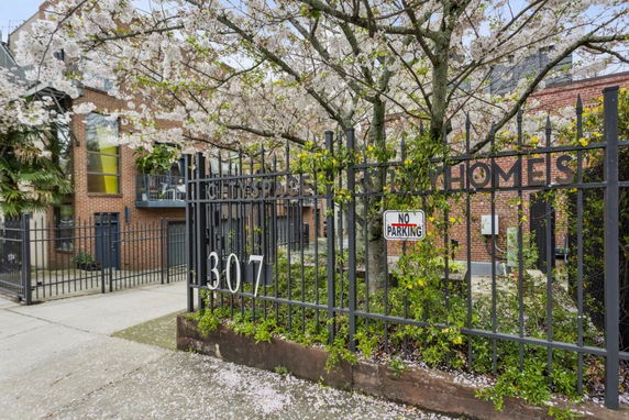 Front view of a building with a gated entrance and a brick facade.
