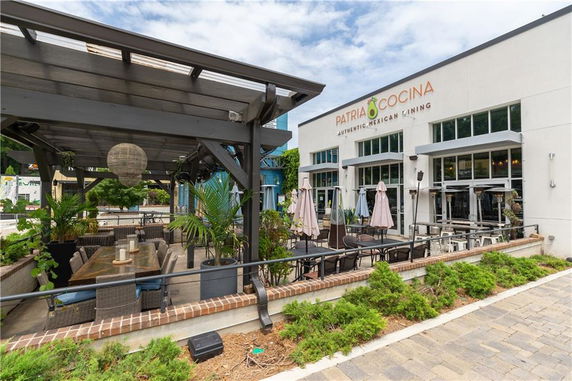 Front view of a restaurant with outdoor seating area.