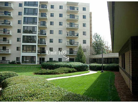 Front view of a multi-story apartment building with balconies.