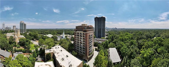 Panoramic view of urban neighborhood with tall buildings and greenery.