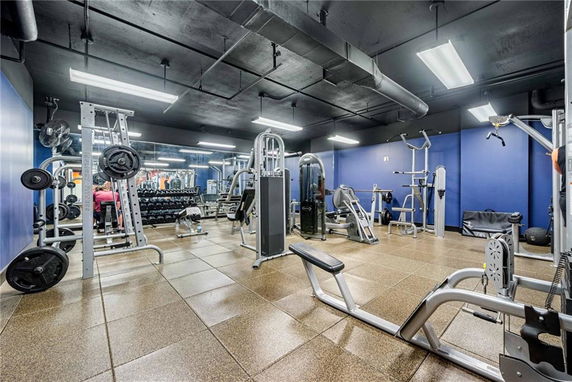 Interior view of a gym with various fitness equipment and weight machines.