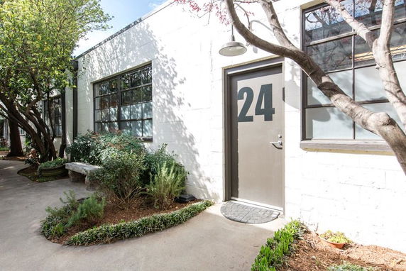 Front view of a single-story building with a door labeled '24'.