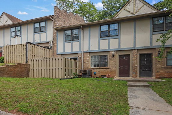 Front view of a two-story townhouse with brick and panel exterior.