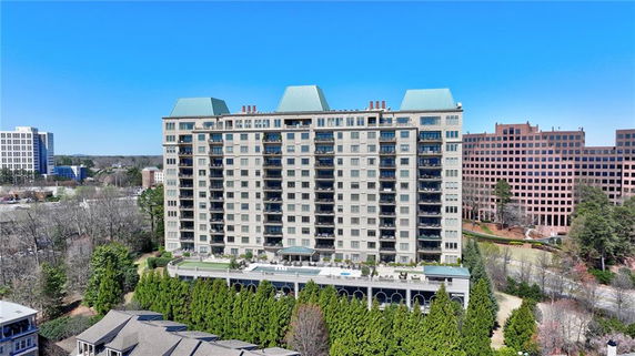 Front view of a multi-story building with multiple balconies.