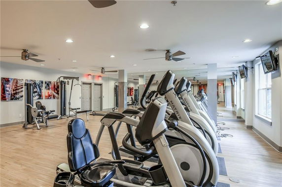Indoor gym area with exercise machines and equipment.