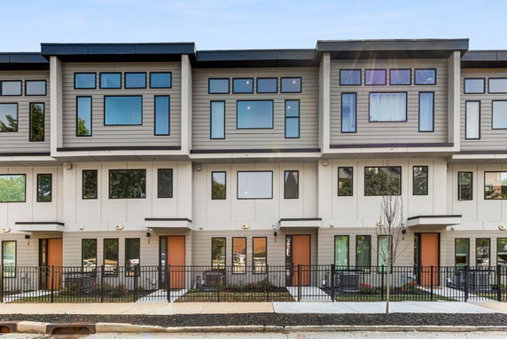 Front view of a modern multi-story townhouse building.