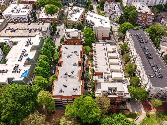Aerial view of multiple residential buildings in an urban area with surrounding greenery.