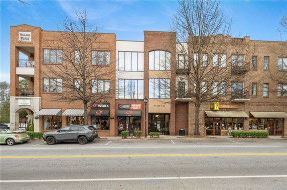 Front view of a multi-story commercial and residential building.