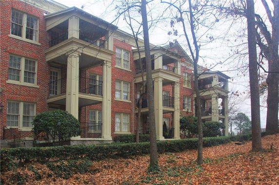 Front view of a multi-story brick building with balconies.