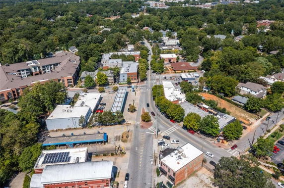 Aerial view of a town with buildings, roads, and greenery.