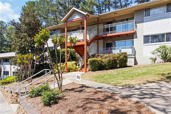 Front view of a two-story apartment building with a central staircase.