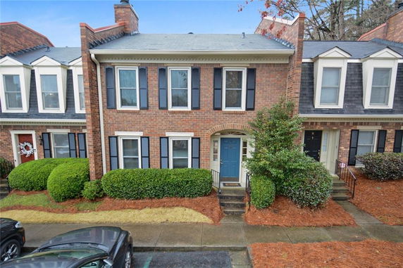 Front view of a two-story townhouse with brick facade.