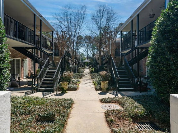 Front view of a multi-story building with outdoor staircases and balconies.