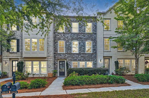 Front view of a multi-story townhouse with brick facade.