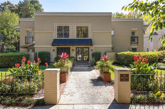 Front view of a two-story house with a central entrance and symmetrical windows.