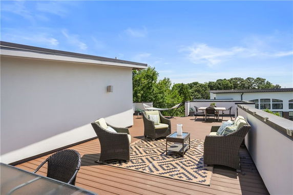 Rooftop terrace with outdoor seating and a hammock.