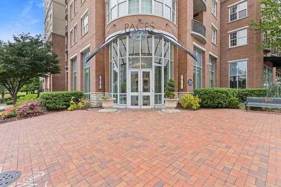 Front view of a multi-story brick building with large glass entrance.