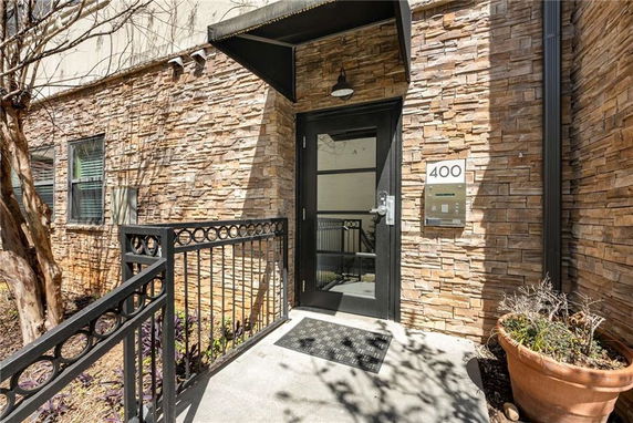 Entrance of a building with stone facade and glass door.