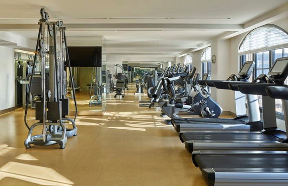 Interior view of a gym with treadmills and exercise equipment.