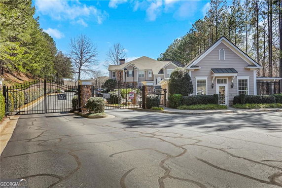 Front view of a residential entrance with a gated community.