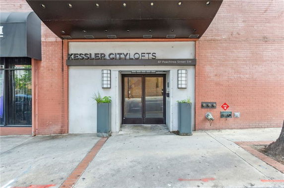 Front view of an urban building entrance with modern signage.