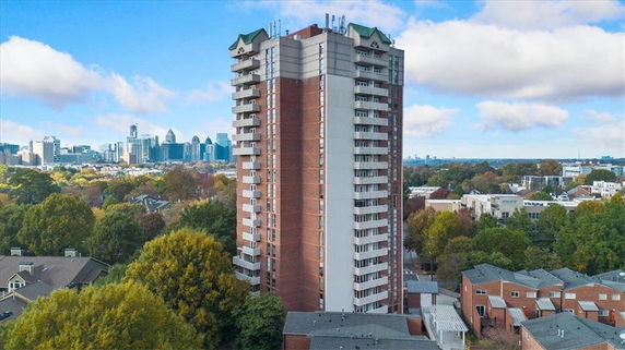Elevated view of a multi-story residential building with balconies.