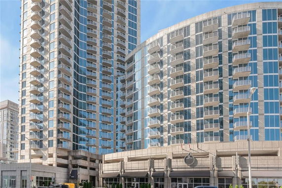 Front view of a high-rise building with numerous balconies.