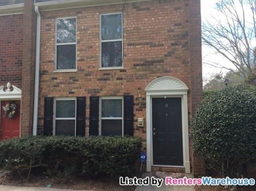 Front view of a two-story brick townhouse.