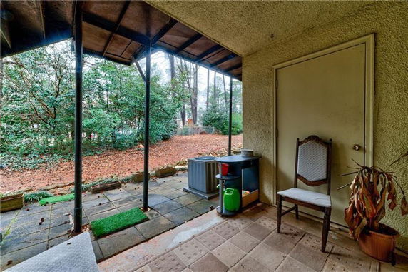 Patio area with a view of trees and outdoor surroundings.