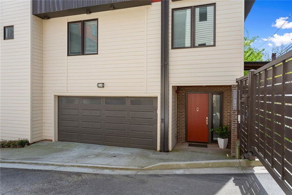 Front view of a house with a double garage and entrance door.