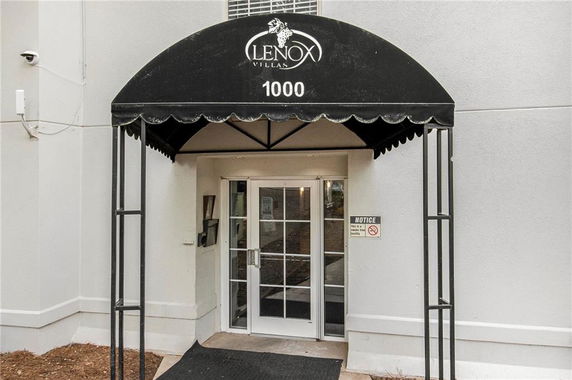 Entrance of a building with an awning labeled 'Lenox Villas 1000'.