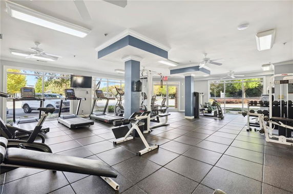 Modern gym area with various exercise equipment.