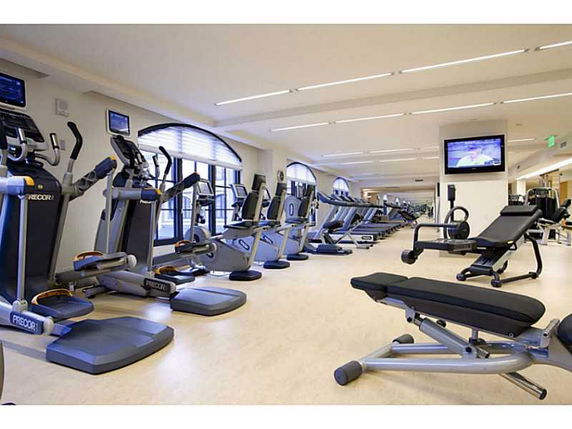Indoor gym with exercise equipment and treadmills.
