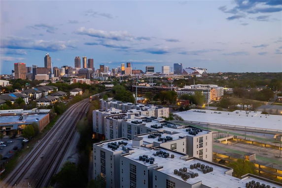 Panoramic view of a cityscape with buildings and railway tracks.