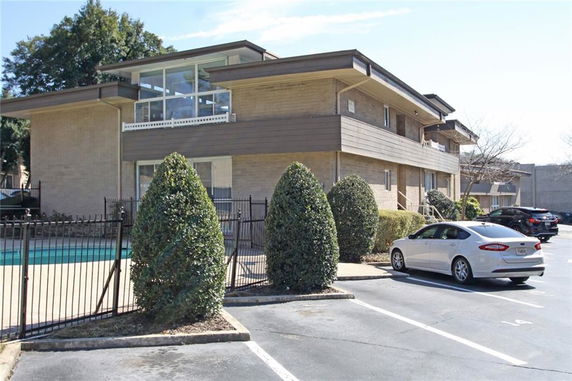 Front view of a two-story residential building with large windows and balconies.