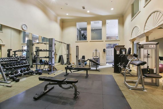 Indoor gym area with various exercise equipment.