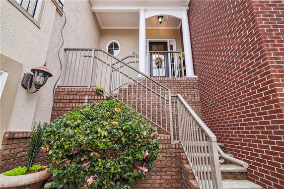 Front view of a house with brick stairs and columns.