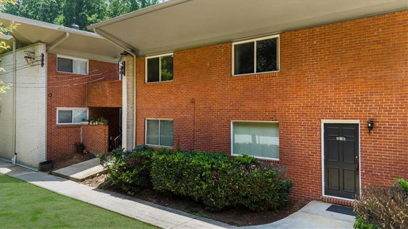 Front view of a brick two-story apartment building.