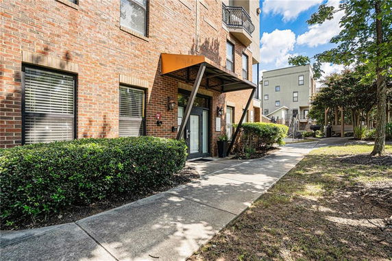Front view of a brick building with a modern entrance canopy.