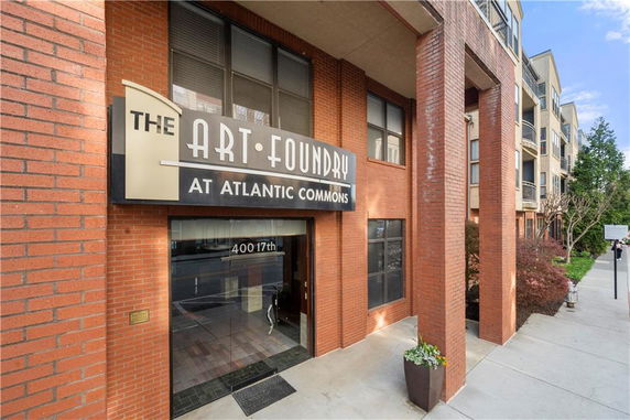 Front view of a multi-story building with a sign reading 'The Art Foundry at Atlantic Commons.'