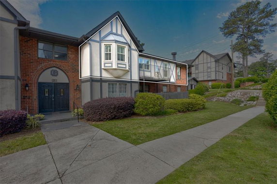 Front view of a two-story building with Tudor-style architectural details.