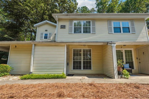 Front view of a two-story house with a covered porch area.