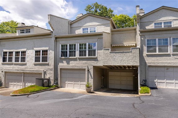 Front view of a multi-story townhouse with garage.